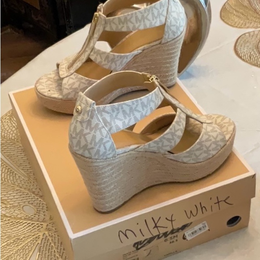 Beautiful pair of wedges by Michael Kors. Size 6.5, beige and cream in color.